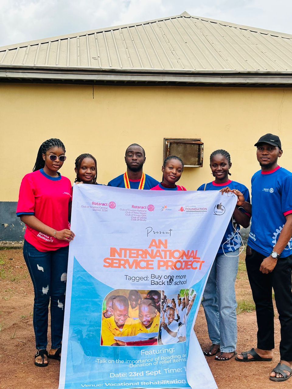 Chisom Nwodo and her Rotaract team holding the International Service Project banner